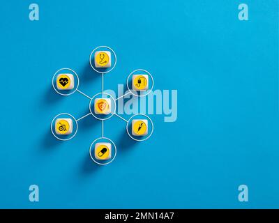Health insurance and healthcare concept. Health insurance symbols on wooden cubes on blue background. Stock Photo