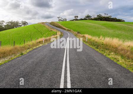 Winding road through Adelaide Hills farms during winter season, South Australia Stock Photo