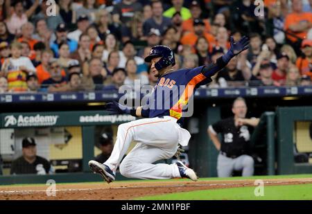 Houston Astros' Yuli Gurriel scores past Boston Red Sox catcher Christian  Vazquez on a sacrifice flay by Jose Altuve during the eighth inning in Game  1 of baseball's American League Championship Series