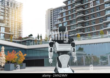 Robot assistant walking in front of building. Concept, idea Stock Photo