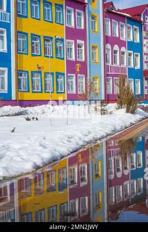 Colorful bright house. The building of the school and kindergarten for children. Architecture of Ukraine. Ukrainian village. Reflection in a puddle. Stock Photo