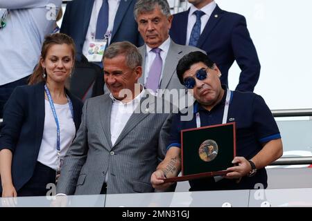 Former Argentina's soccer star Diego Maradona, left, shields the