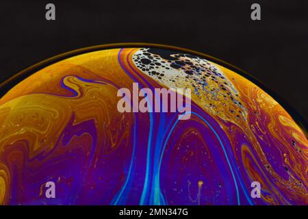 Beautiful psychedelic abstractions on the surface soap bubbles. Stock Photo
