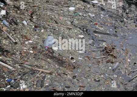 A giant floating rubbish heap floating in the river, plastic pollution ...