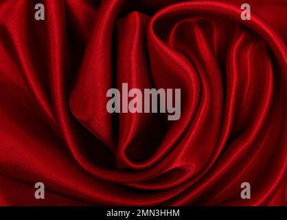Smooth elegant red silk or satin luxury cloth texture as abstract  background. Luxurious valentines day background design Stock Photo