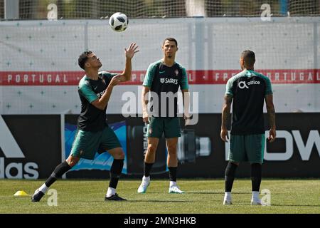 Portugal's Cristiano Ronaldo heads the ball during a team training