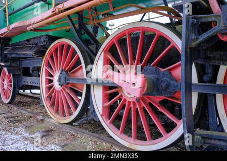 Old steam locomotive wheel and connecting rods. Tie rod or side rod for drive wheels. A retro specimen. Stock Photo