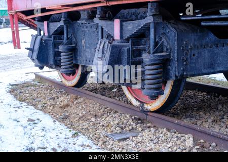 Old steam locomotive wheel and connecting rods. Tie rod or side rod for drive wheels. A retro specimen. Stock Photo