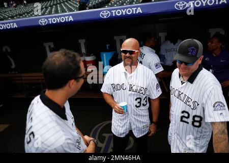 From left, retired Colorado Rockies first baseman Todd Helton is joined by  his daughter Gentry Grace, wife Christy and oldest daughter Tierney Faith  during a ceremony at which the player's number was