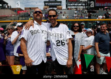 From left, retired Colorado Rockies first baseman Todd Helton is joined by  his daughter Gentry Grace, wife Christy and oldest daughter Tierney Faith  during a ceremony at which the player's number was