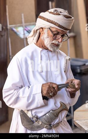 Nizwa, Oman, 2nd December 2022: omani man in traditional outfit at the weapon market Stock Photo