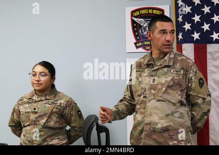 U.S. Army Spc. Jennifer M. Sanchez, Property Book NCO, 92Y, for Headquarters and Headquarters Company, 36th Combat Aviation Brigade, 'Task Force Mustang,' 36th Infantry Division (left), is introduced to the brigade command group by 1st Sgt. Borislav D. Manchev, first sergeant of HHC, 'Hellfires', Task Force Mustang, receives a Certificate of Appreciation as the brigade's 'Hero of the Week' during a command and staff meeting held at Task Force Mustang headquarters, Camp Buehring, Kuwait, Sept. 28, 2022. Sanchez, a native of Nacogdoches, Texas, was recognized for her stellar performance and admi Stock Photo
