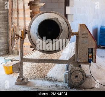 Worker uses a concrete made ??of a concrete mixer Stock Photo
