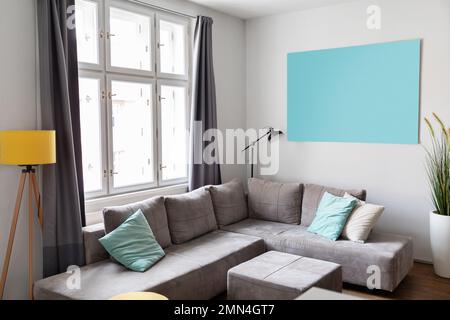 Cozy living room interior with comfortable grey sofa and big window Stock Photo