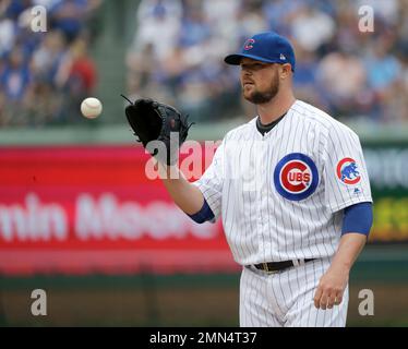 Chicago Cubs new starting pitcher Jon Lester poses for photos with