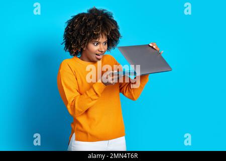 Amazed black woman open laptop and looking at sceen Stock Photo