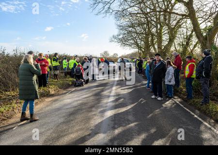 Alderholt, Dorset, England, UK, UK, 30th January 2023. People from the quiet village and surrounding areas gather to protest at Hampshire County Council’s decision to permit the development of a large gravel extraction site at Midgham Farm. The proposed development in green fields on the village doorstep sits within the Hampshire boundary and has objections from Dorset County Council, local town councils, politicians and protestors under the group name Residents Against Gravel Extraction – RAGE. Credit: Paul Biggins/Alamy Live News Stock Photo