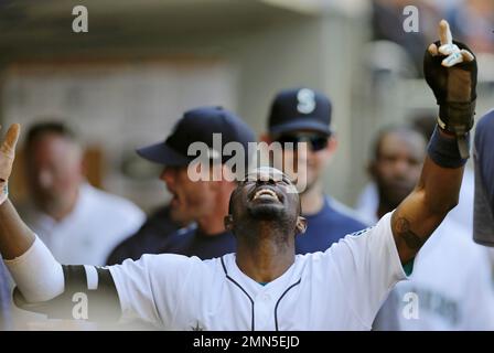 Seattle Mariners' Dee Gordon celebrates in the dugout after a home