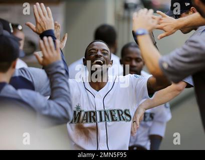 Seattle Mariners' Dee Gordon celebrates in the dugout after a home