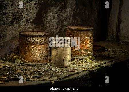 Rusty dirty cans and a dirty jar on a shelf in abandoned house, Pennsylvania, USA Stock Photo