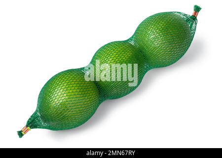 Three fresh green limes in a green bag close up isolated on white background Stock Photo