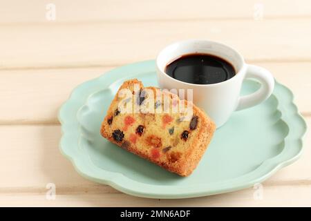 Slice Fruit Cake with a Cup of Coffee, on Ceramic Plate Stock Photo