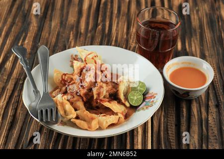 Batagor Baso Tahu Goreng, Deep Fried Fish Dumpling with Peanut Sauce and Soy Sweet Sauce. Popular Street Food from Bandung Stock Photo