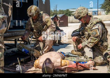 Staff Sgt. Caleb Stinson (left) and Sergeant 1st Class Jason Pate (right), 68W Combat Medics, 232nd and 187th Medical Battalions, conduct damage control and resuscitation during the Best Medic Competition, Sep. 29, 2022 at Joint Base San Antonio-Camp Bullis, Tx. Medics who earn entry into the Best Medic Competition are already among the 'best of the best.' To be eligible for entry, medics must have received either the Expert Field Medical Badge (EFMB) or the Combat Medical Badge (CMB).2 Both badges require the utmost determination and competence to receive. The overall pass rate for the Expert Stock Photo