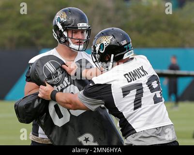 Jacksonville Jaguars defensive lineman Calais Campbell (93) and defensive  end Hunter Dimick (79) walk to the field before an NFL football practice,  Friday, May 26, 2017, in Jacksonville, Fla. (AP Photo/John Raoux