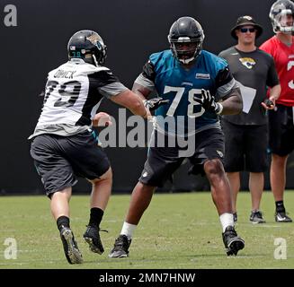 Jacksonville Jaguars defensive lineman Calais Campbell (93) and defensive  end Hunter Dimick (79) walk to the field before an NFL football practice,  Friday, May 26, 2017, in Jacksonville, Fla. (AP Photo/John Raoux