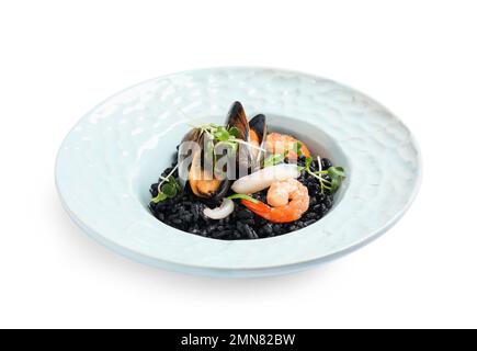 Delicious black risotto with seafood isolated on white Stock Photo