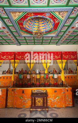 Buddhist altar or shrine, interior of the Manna Hall, with its beautifully elaborate painted ceiling and numerous small Buddha figurine statues on the table, inside the famous Daci'en Temple in the Yanta district of Xi'an. China. PRC. (125) Stock Photo