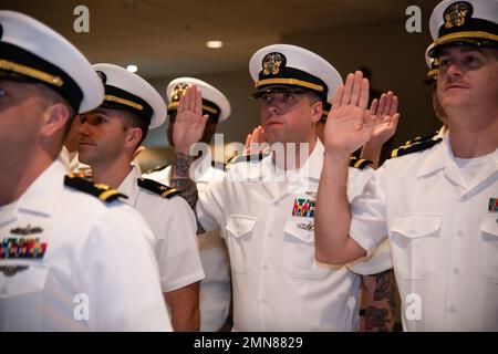 NEWPORT, RI. (Sept. 30, 2022) Limited Duty Officer/Chief Warrant Officer (LDO/CWO) Academy class 22120 students at Officer Training Command Newport (OTCN), reaffirm the oath of office during their graduation ceremony, Sept. 30, 2022. The LDO/CWO community supports the warfighting capability and readiness of Naval forces through leadership, technical proficiency, and experience. Stock Photo