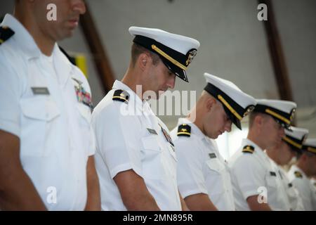 NEWPORT, RI. (Sept. 30, 2022) Officer Development School (ODS) class 22080 students at Officer Training Command Newport (OTCN), Rhode Island, lower their heads for the invocation during their graduation ceremony, Sept. 30, 2022. ODS provides staff corps officers and several restricted line designators with training necessary to prepare them to function in their role as newly commissioned Naval officers. Stock Photo