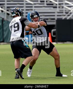 Jacksonville Jaguars defensive lineman Calais Campbell (93) and defensive  end Hunter Dimick (79) walk to the field before an NFL football practice,  Friday, May 26, 2017, in Jacksonville, Fla. (AP Photo/John Raoux