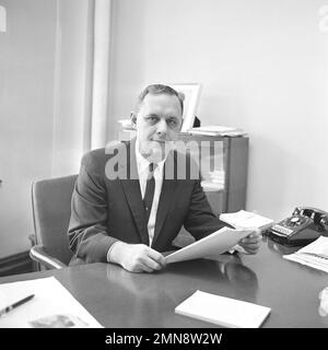 Owner-coach George Halas of the Chicago Bears announced the election of his  son George Mugs Halas Jr., 38 and shown at his desk in Chicago, as  president and general manager of the