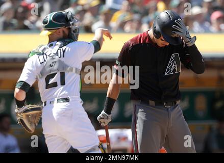 Arizona Diamondbacks' Jake Lamb, right, gets a pie in the face from  teammate Adam Jones after a baseball game win against the Miami Marlins,  Monday, Sept. 16, 2019, in Phoenix. Lamb delivered