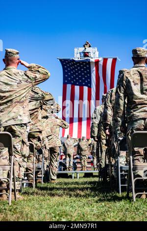 Soldiers with the 76th Infantry Brigade Combat Team salute the U.S. flag during the national anthem during their departure ceremony at Camp Atterbury near Edinburgh, Friday, Sept. 30, 2022. Stock Photo