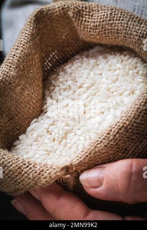 Hand Sack Rice White rice in the hand in burlap sack Stock Photo - Alamy