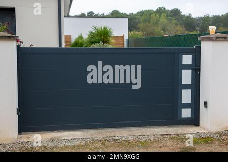 portal aluminum sliding grey metal gate high of modern gray suburb house entrance Stock Photo