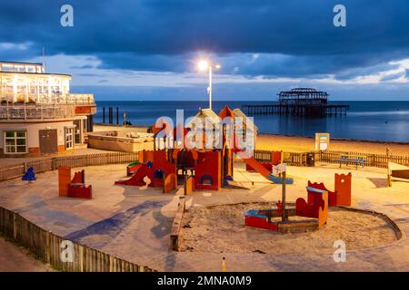 Night falls on the lower esplanade of Brighton seafront, East Sussex, England. Stock Photo