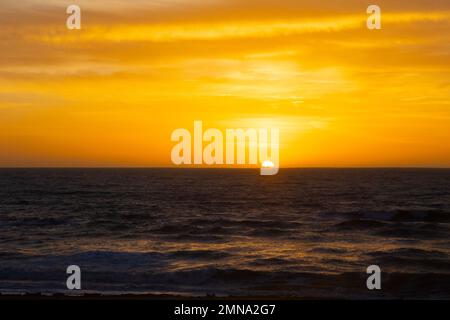 Sun Setting over Pacific Ocean Stock Photo