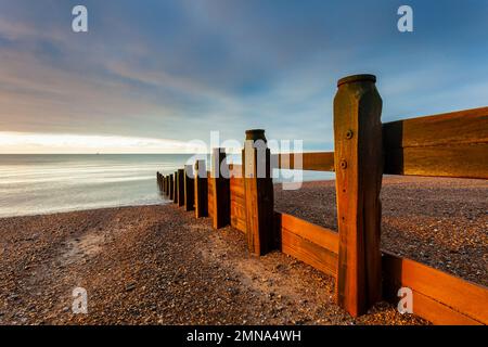 Damaged groyne on Southwick beach at sunrise, West Sussex, England. Stock Photo