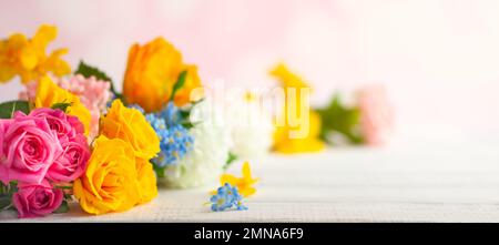 Beautiful spring flowers on white wooden table. Festive concept with copy space. Stock Photo