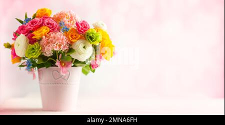 Beautiful spring flowers in vase on white wooden table. Festive concept with copy space. Stock Photo