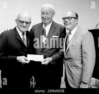 George Halas, owner-president of the Chicago Bears, seems to have some  interested listeners in Jack Jennings, center, of the Chicago Cardinals,  and Chuck Bednarik, right, of the Philadelphia Eagles, as they wait