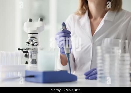 Professional female scientist is working in scientific research laboratory. Stock Photo
