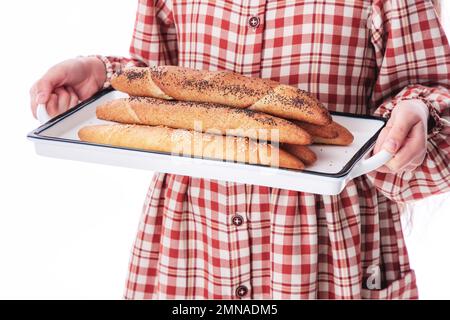 Girl baker in vintage dress serving freshly baked homemade bread rolls with cheese Stock Photo