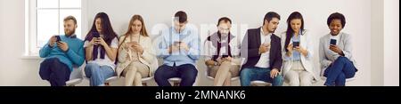 Multiethnic vacancy applicants candidates waiting in queue sitting in row Stock Photo