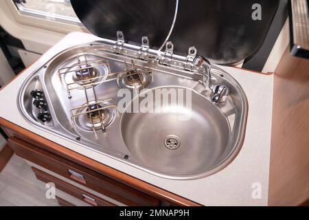 Campervan Kitchen in a mobile house with sink Stock Photo